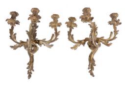 A pair of gilt metal twin light wall appliques in Louis XV taste, first half 20th century, cast as