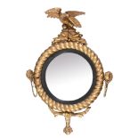 A George III giltwood and composition circular convex wall mirror , circa 1810, with eagle