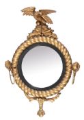A George III giltwood and composition circular convex wall mirror , circa 1810, with eagle