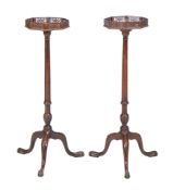 A pair of mahogany torcheres in George III style, late 19th/early 20th century, each octagonal top