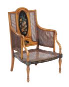 A Sheraton Revival simulated satinwood and painted bergere armchair , first quarter 20th century,