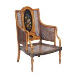 A Sheraton Revival simulated satinwood and painted bergere armchair , first quarter 20th century,