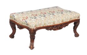 A Victorian carved walnut centre stool, circa 1870, the moulded frieze and legs carved with carved