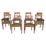 A set of eight George IV mahogany dining chairs, circa 1825, each scrolling bar splat centred by a