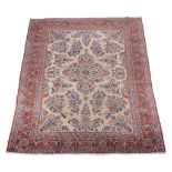 A Kashan carpet, the cream field profusely decorated with sprigs of flowers in tones of blue and