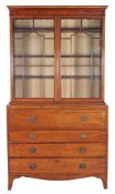 A George III mahogany and glazed secretaire bookcase , circa 1800, the ebony strung secretaire