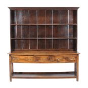 An oak dresser base in George III style , early 20th century, of large proportion, with associated