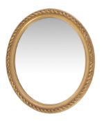 A giltwood oval wall mirror , in Regency style, late 19th century, with rope-twist frame, 92cm