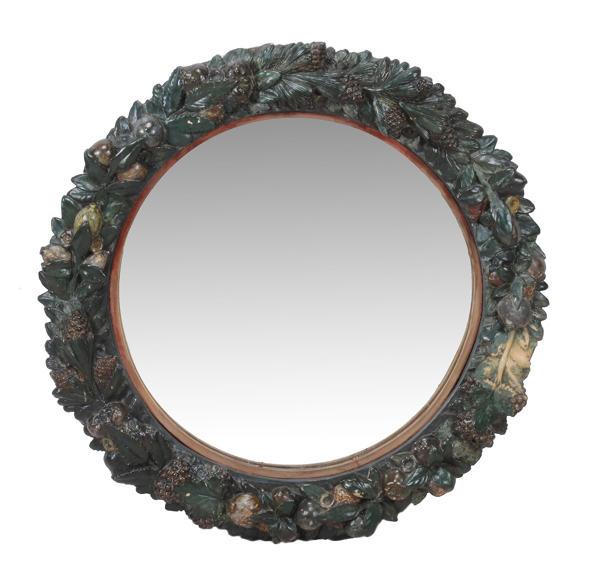 A Continental painted terracotta wall mirror, second half 19th century, the circular plate within
