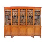 A George III mahogany breakfront library bookcase, circa 1800, the moulded cornice above five