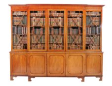 A George III mahogany breakfront library bookcase, circa 1800, the moulded cornice above five