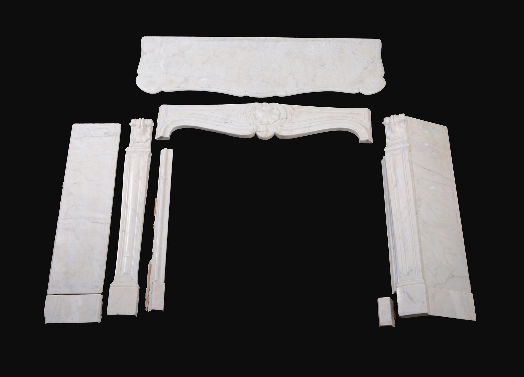 A Victorian carved white marble chimneypiece in Louis XV taste, late 19th century, the loosely