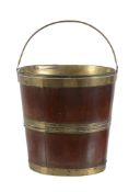 A George III mahogany and brass bound 'kettle stand' or oyster bucket, circa 1800, of coopered