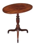 A George III mahogany oval tripod table , circa 1790, 73cm high, the oval strung top above a turned