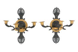 A pair of fine Empire gilt and patinated bronze three light wall appliques, early 19th century, the