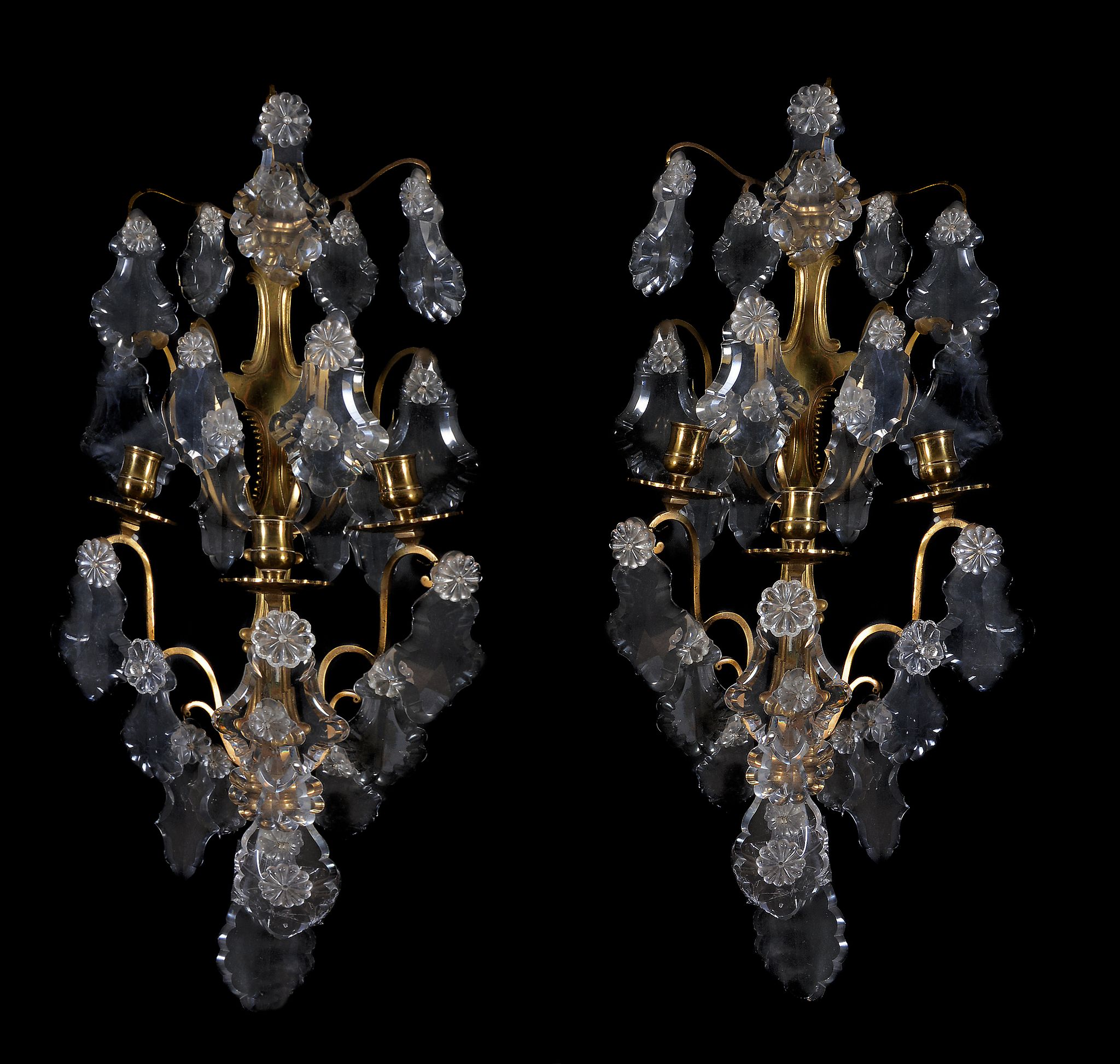 A pair of brass and cut glass hung three light wall appliques, early 20th century, the sconces