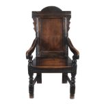 A Charles II panel back armchair, circa 1660, the arched panel back, above downswept arms and a