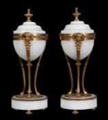A pair of French white marble and gilt bronze mounted urns, circa 1870, each with toupie finial,
