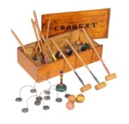 A table top croquet set in late Victorian style , comprising eight malletts, eight corresponding