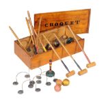 A table top croquet set in late Victorian style , comprising eight malletts, eight corresponding