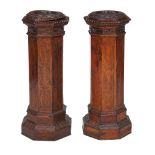 Two similar walnut pedestals , circa 1900, each of octaganol section, each 99cm high, the tops 38cm