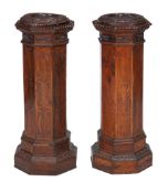 Two similar walnut pedestals , circa 1900, each of octaganol section, each 99cm high, the tops 38cm