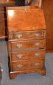 A modern burr walnut bureau, of narrow proportion, the fall enclosing a fitted interior above four