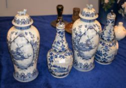 A pair of Delft blue and white ovoid vases and covers, circa 1900, painted with panels of windmills,