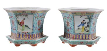 A small pair of Chinese Famille Rose jardinières and stands, 20th century painted with panels of