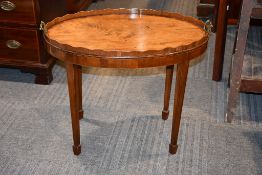 A George III mahogany and crossbanded oval tray with brass handles on later stand, as a coffee