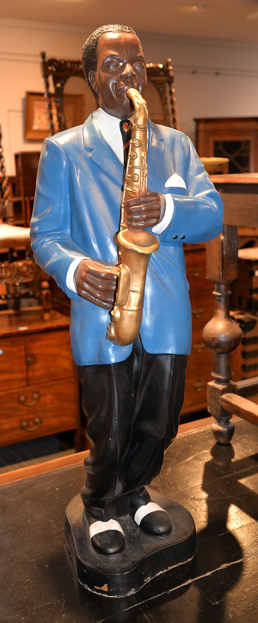 A painted fibreglass model of a standing saxophonist, modeled as soloing, 102cm high