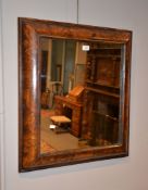 A walnut and marquetry inlaid cushion frame wall mirror, parts possibly 17th century, the plate