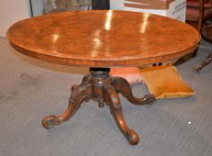 A mid-Victorian walnut tilt-top loo table, the quarter-bookmatched top above turned pillar and