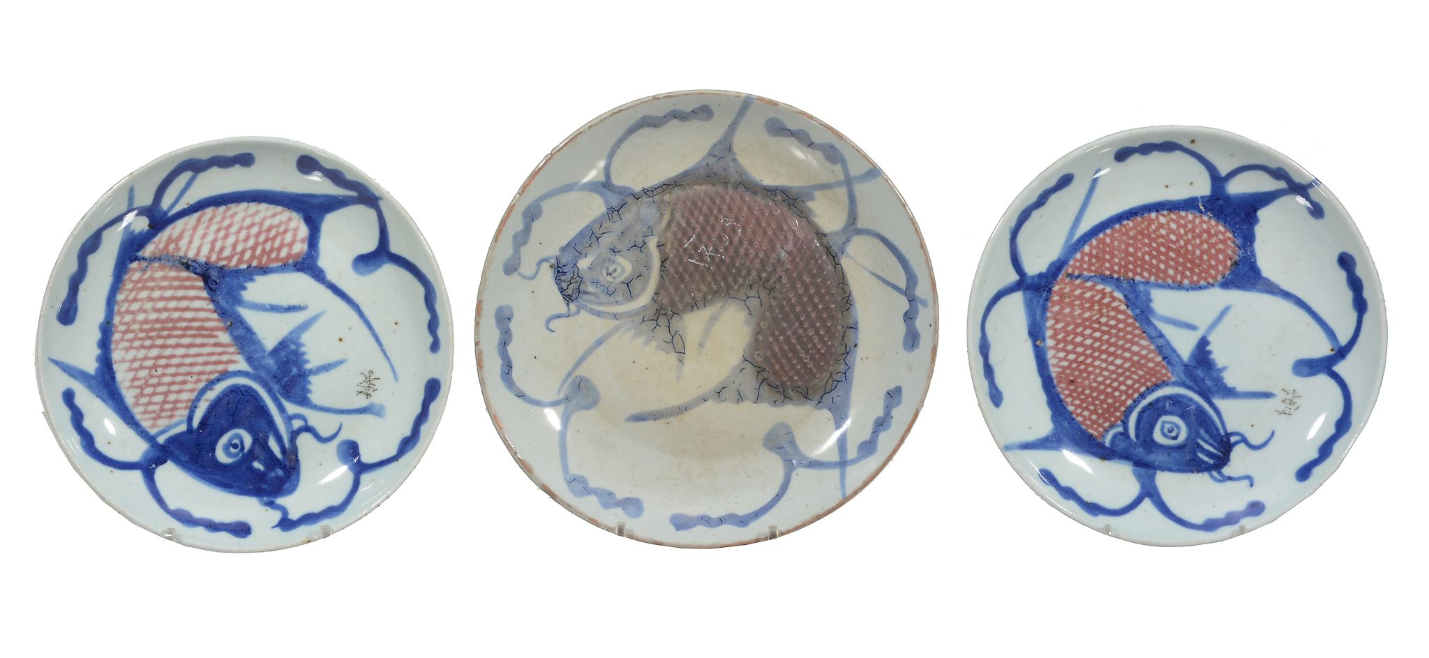 Three provincial Chinese blue and white fish plates, 19th century, painted with fished in blue and