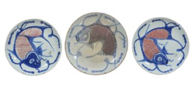 Three provincial Chinese blue and white fish plates, 19th century, painted with fished in blue and