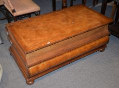 A coffee table/chest in the form of two stacked books, the hinged top opening to compartment, 50cm