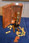 A Victorian lacquered and gilt painted brass monocular microscope, unsigned, in mahogany box, 27cm