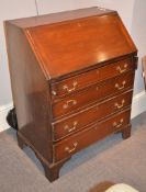 A mahogany bureau in George III style, circa 1920, the fall enclosing a fitted interior, above
