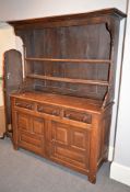 A Welsh oak dresser base, 19th century, with associated plate rack canopy above the base with