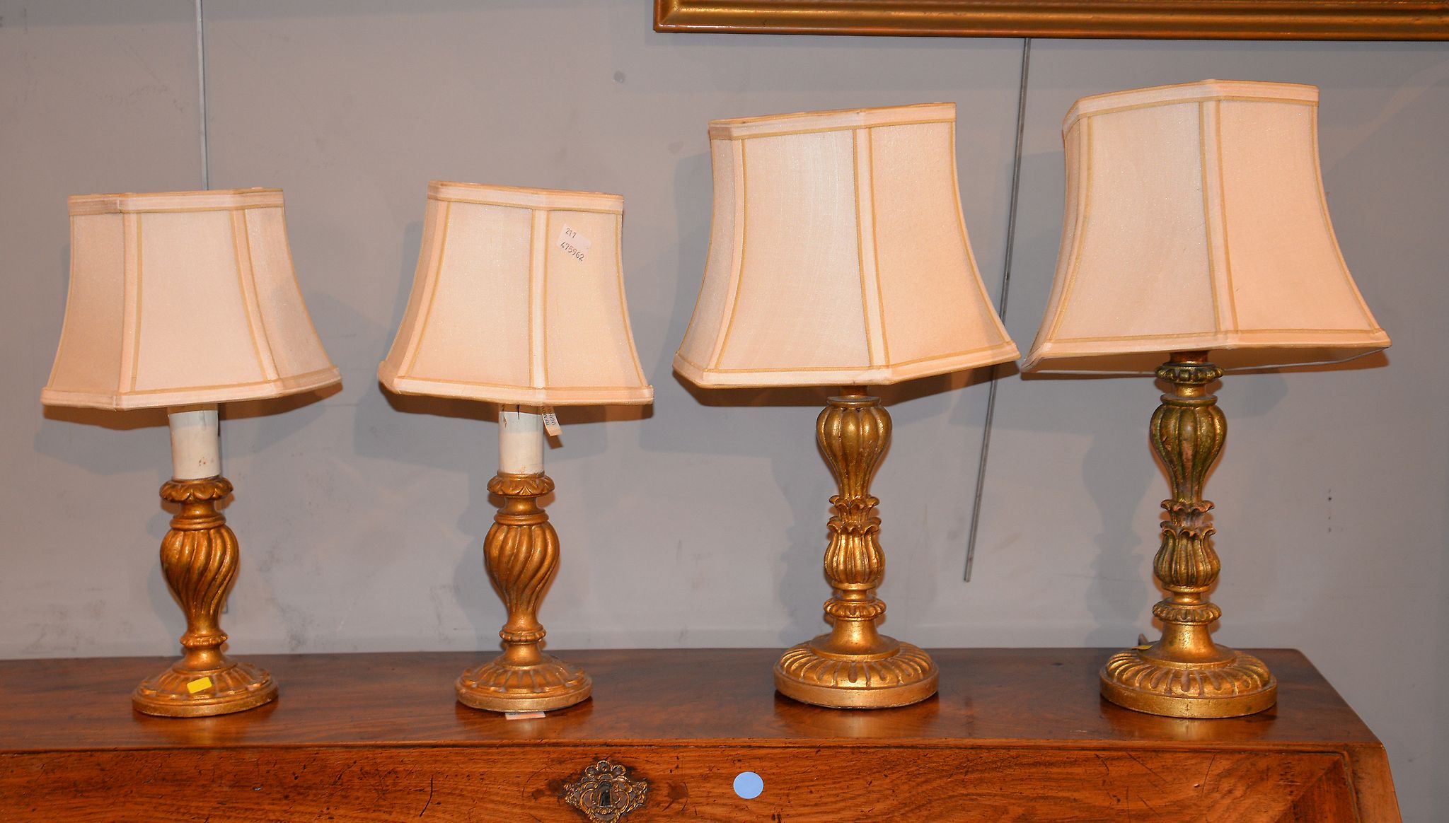 A pair of giltwood baluster lamp bases, 30cm high, and a further pair of similar smaller lamp bases