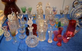 An assortment of clear and coloured glass, including a Bohemian ruby flashed and engraved goblet,