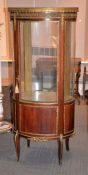 A French mahogany and gilt metal mounted glazed vitrine, early 20th century ,of oval section,