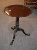 A 19th century mahogany tripod table in George III style, the pie crust top above fluted and