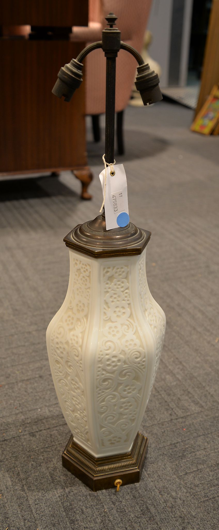 An opaque white glass lamp base moulded in relief in flowering prunus, in Chinese style, 66cm high