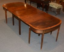 A George III mahogany and crossbanded D-end dining table, with central section with one drop leaf,