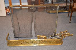 A quantity of fire furniture, comprising a Victorian Gothic style brass fender, 121cm long, a set of