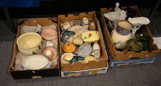 A mixed assortment of ceramics including Westminster pigs, two Poole pottery dolphins and other