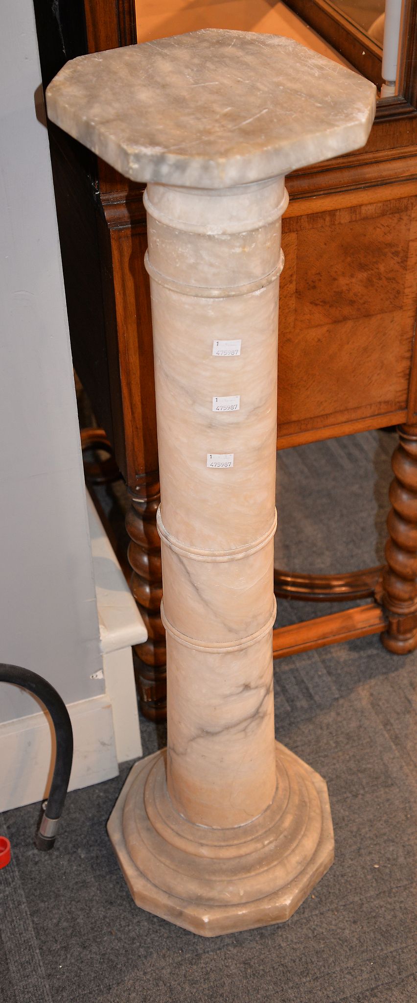 A variegated white marble columnar plinth, the top of octagonal section, 101cm high