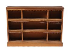 A Victorian walnut open bookcase, with three banks of fixed shelves, each shelf with remains of