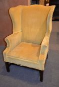 A yellow upholstered wing armchair in George I style, mid-20th century, 116cm high